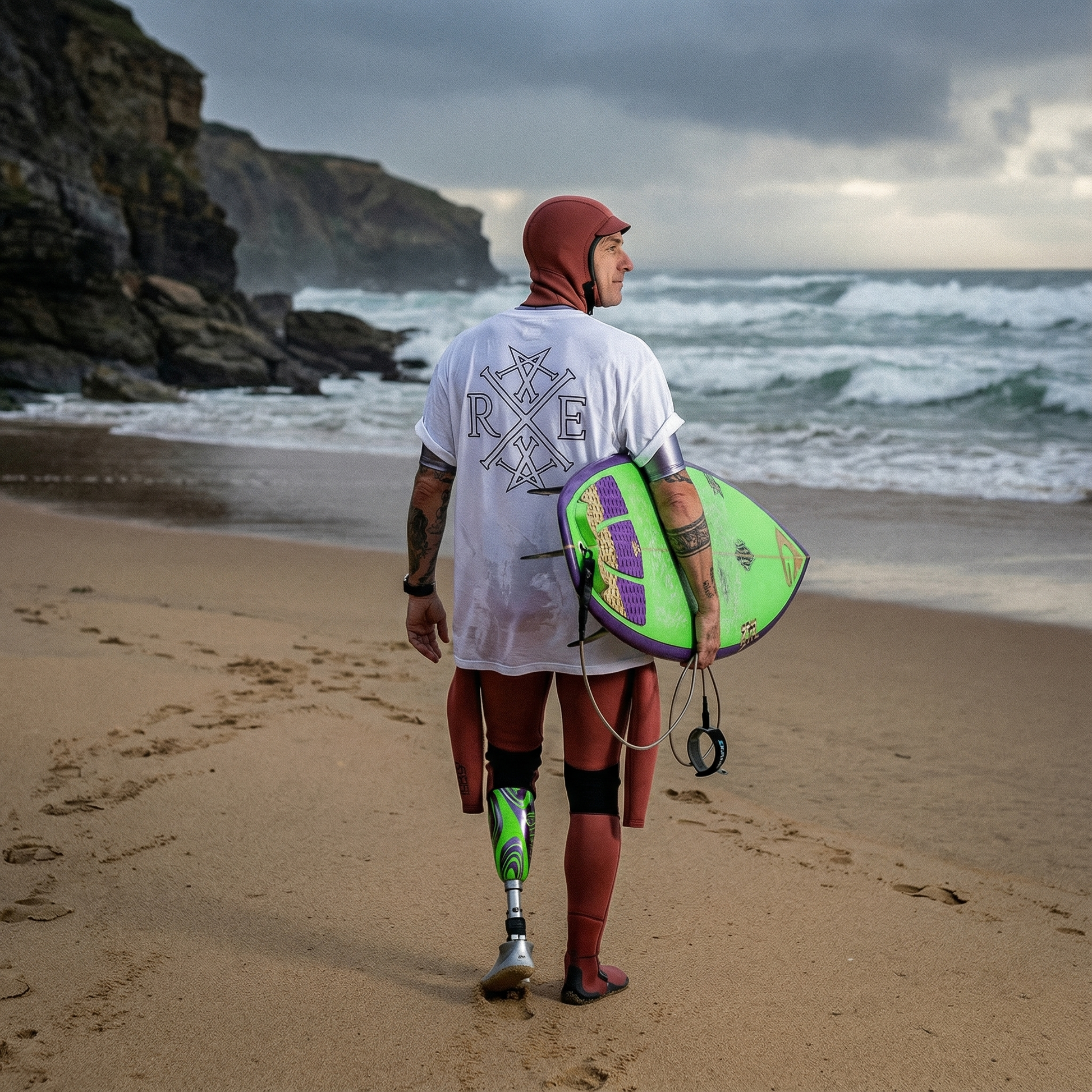 Person with a prosthetic leg walking on a beach holding a green and purple surfboard.